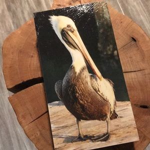 Decoupage pelican art on hard wood.